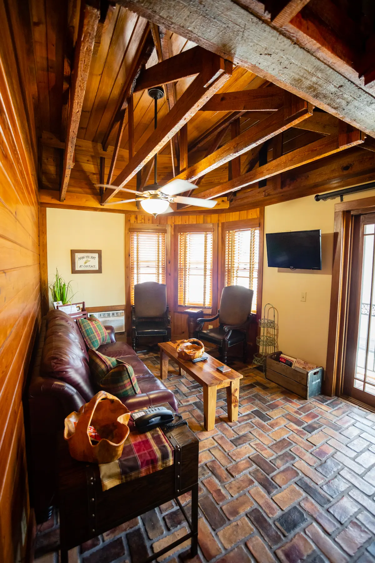 Cozy living room with wooden ceiling beams and comfortable seating.
