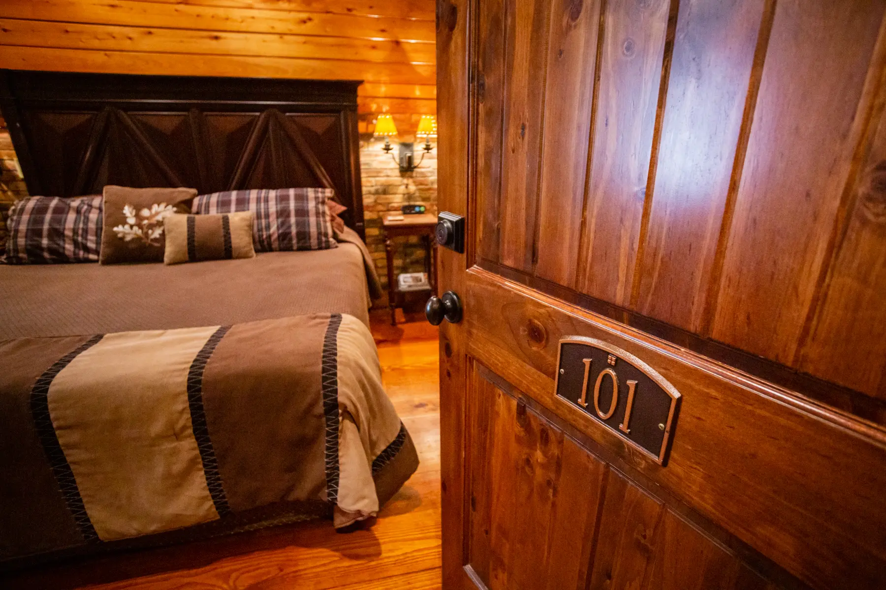 Cozy rustic bedroom with wooden decor and a warm ambiance.