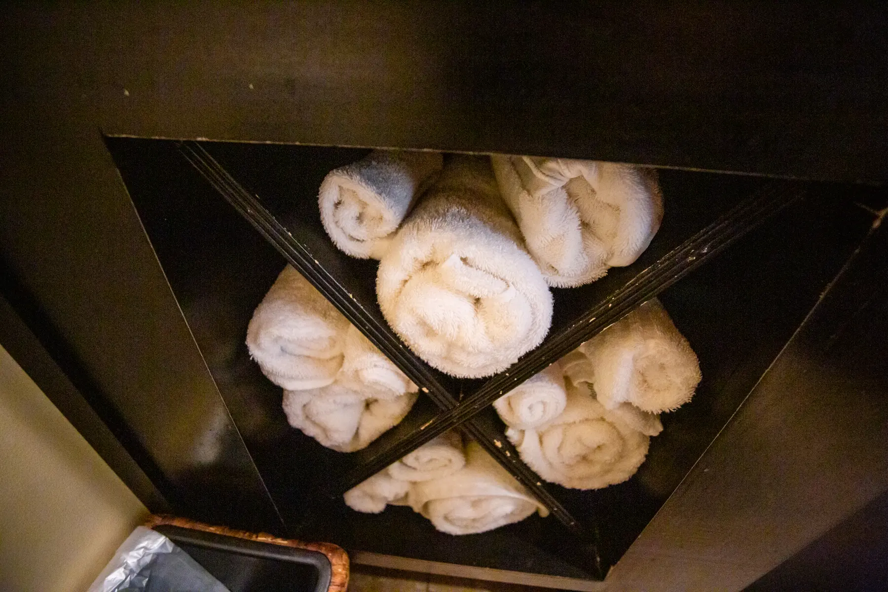 Steamed buns arranged in a bamboo basket with compartments.