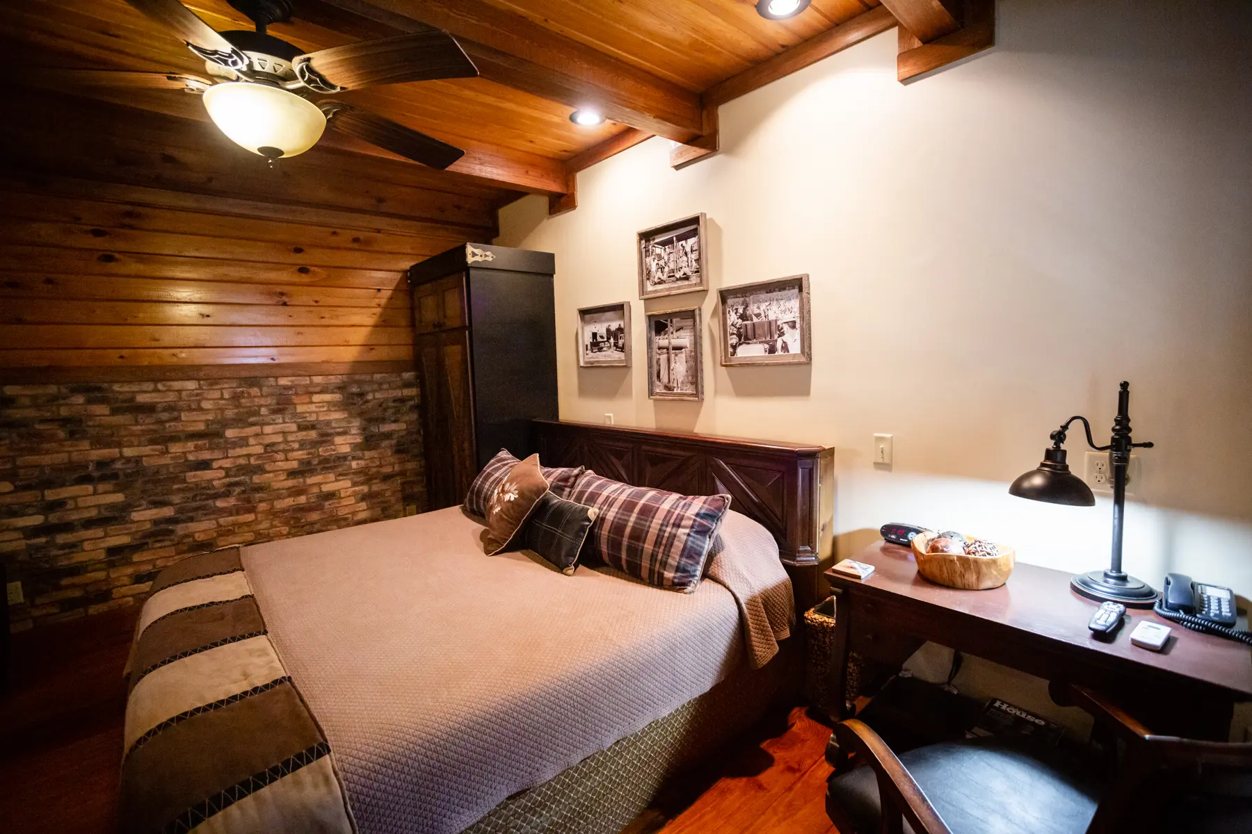 Cozy rustic bedroom with wooden beams and warm lighting.