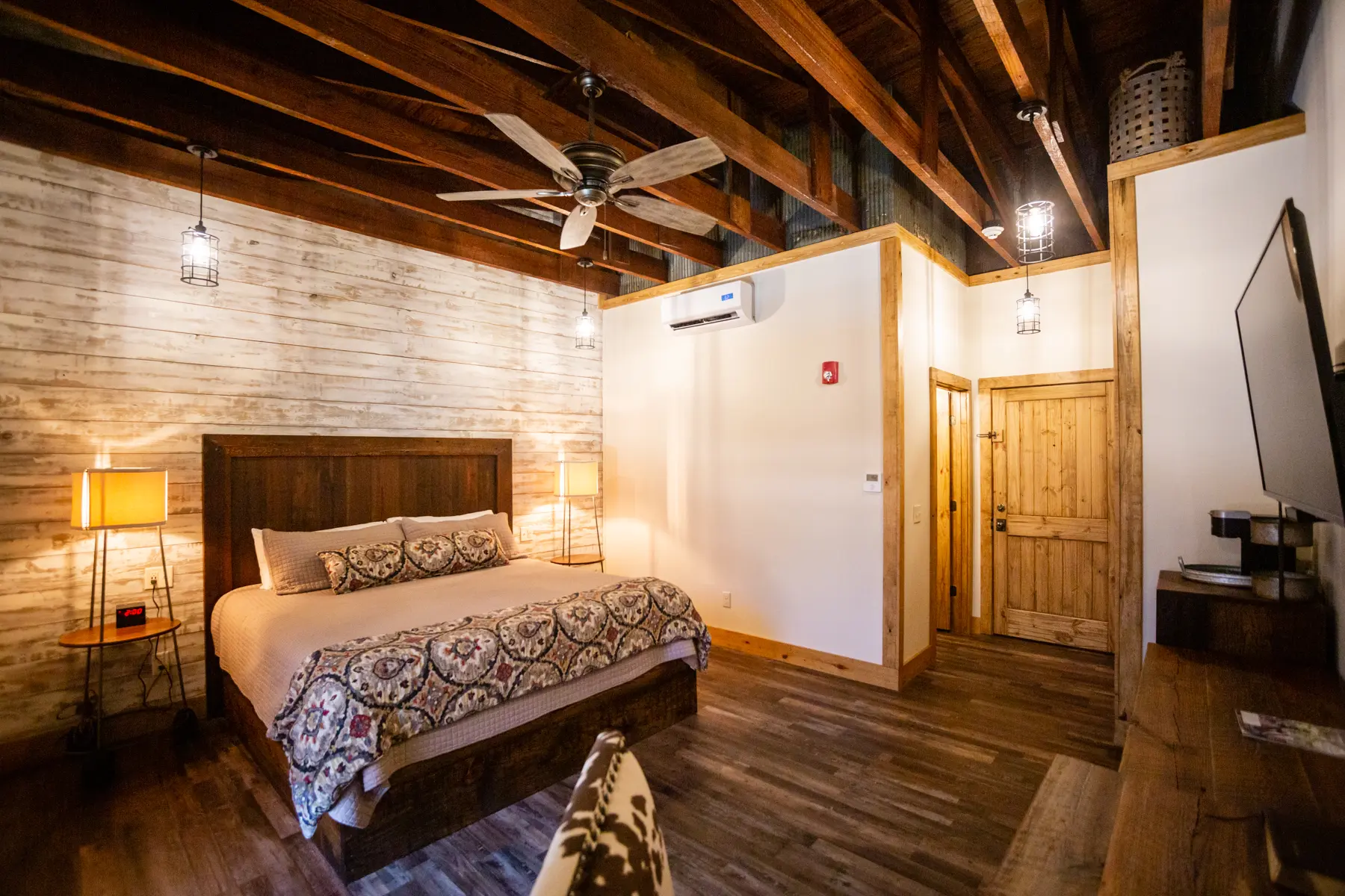 Cozy bedroom with wooden beams and rustic decor.