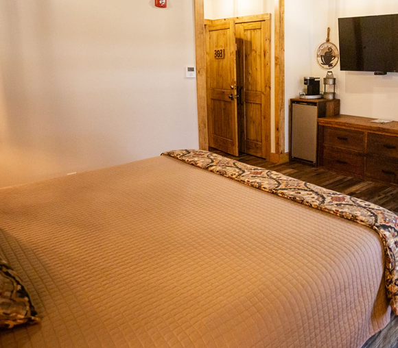Hotel room with wooden doors and TV